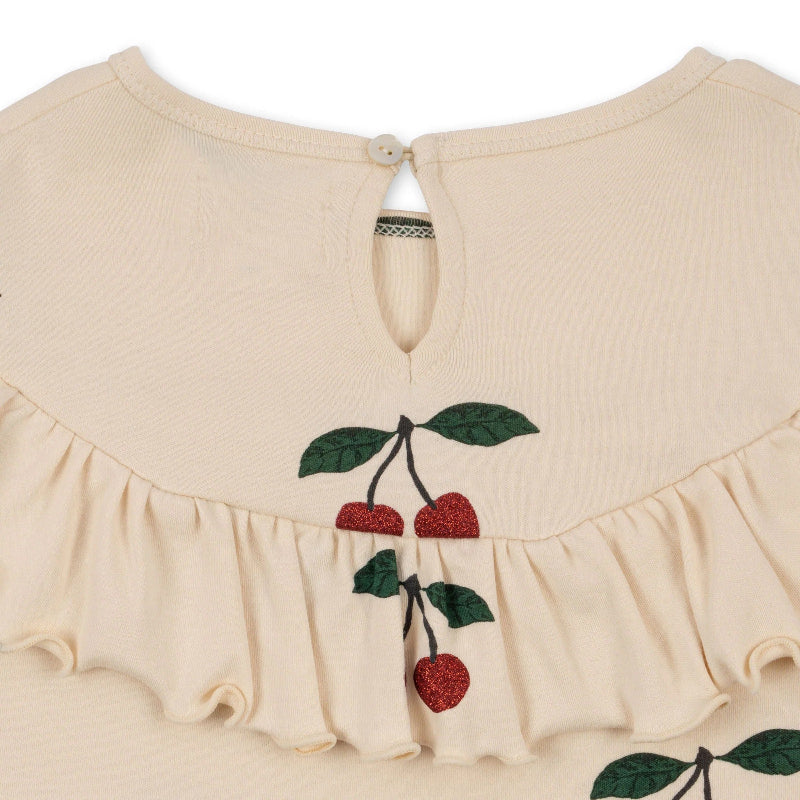 Konges Slojd Malli Glitter Blouse in cream knit with glitter cherry embroidery and back button keyhole with ruffled hem.