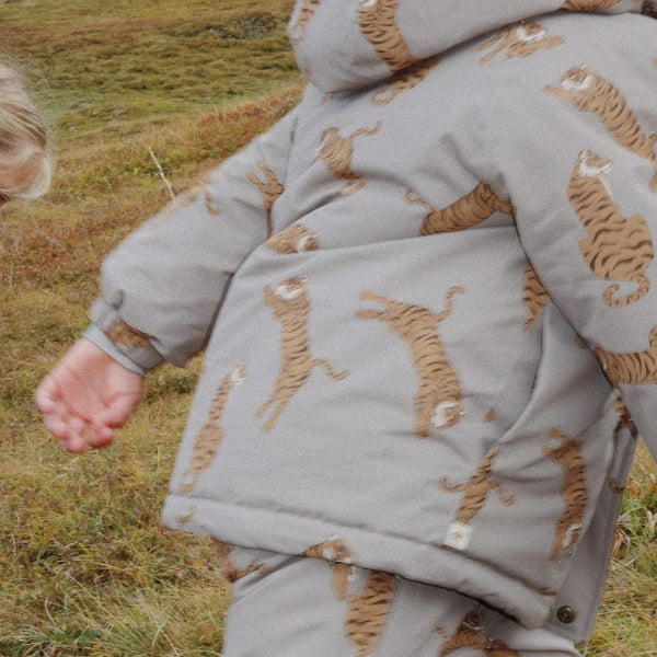 Konges Slojd Mismou Jacket Tiger Oak, gray tiger-print toddler coat worn outdoors by a small explorer.