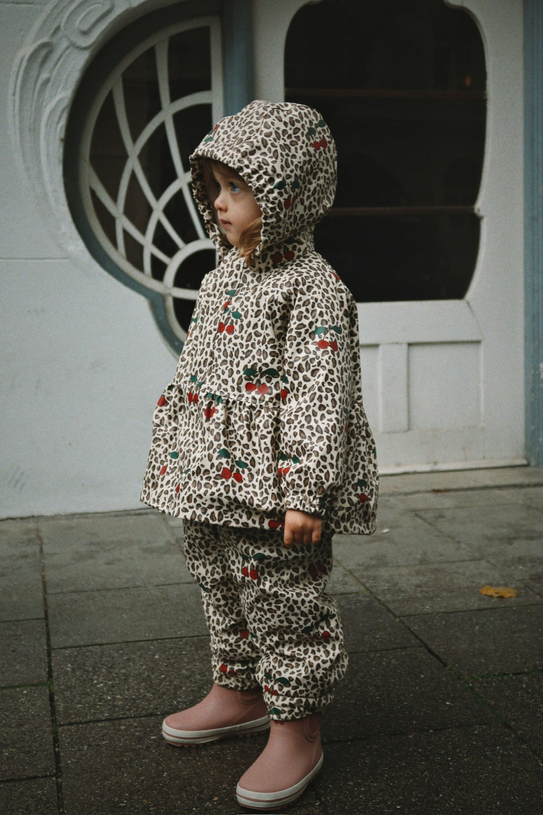 Konges Slojd Rainy Palme Set Leo Cerise, lifestyle view with a child wearing the rainwear 3