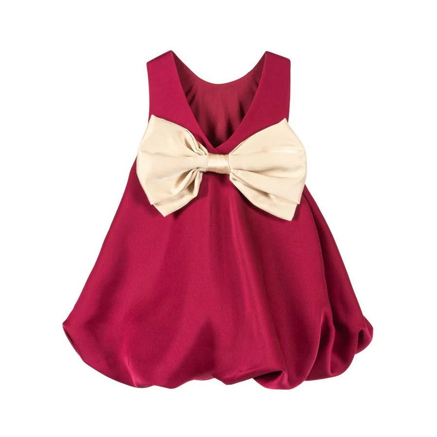 Konges Slojd Sheena Dress Sangria; deep red baby dress with a beige waist bow, sleeveless and voluminous.