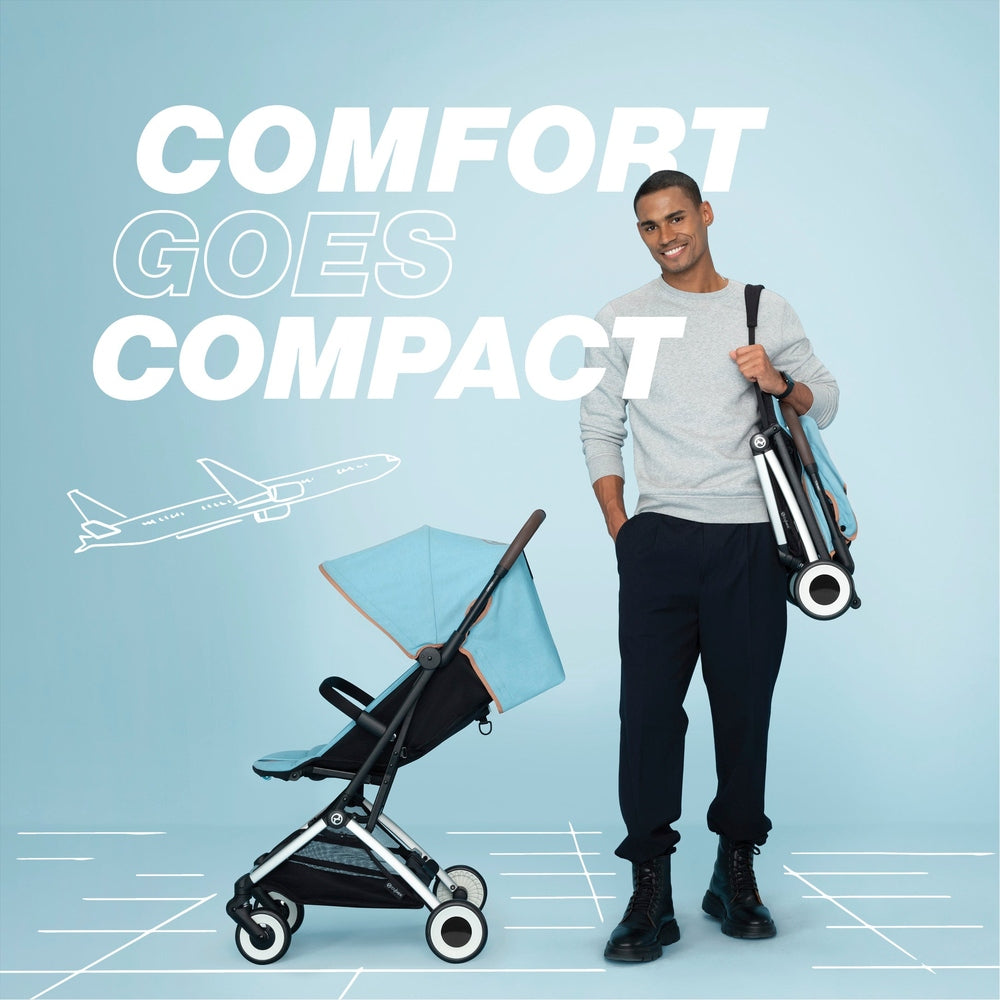 Lifestyle image of a man carrying the folded Cybex Orfeo stroller beside the open stroller.
