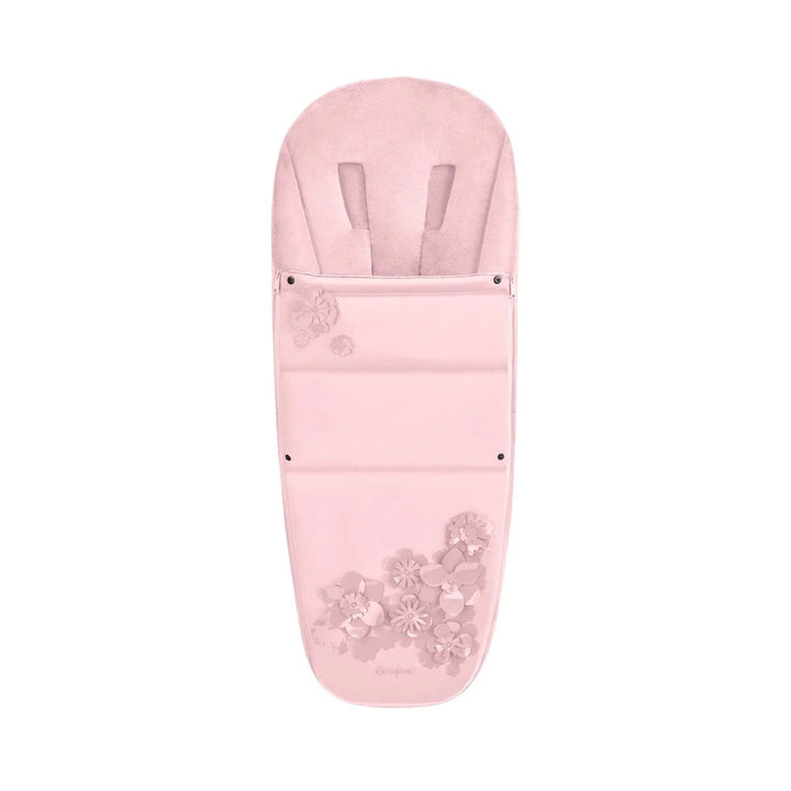 Lifestyle image of the Cybex Footmuff in soft pink with flower appliques, cozy baby stroller accessory.