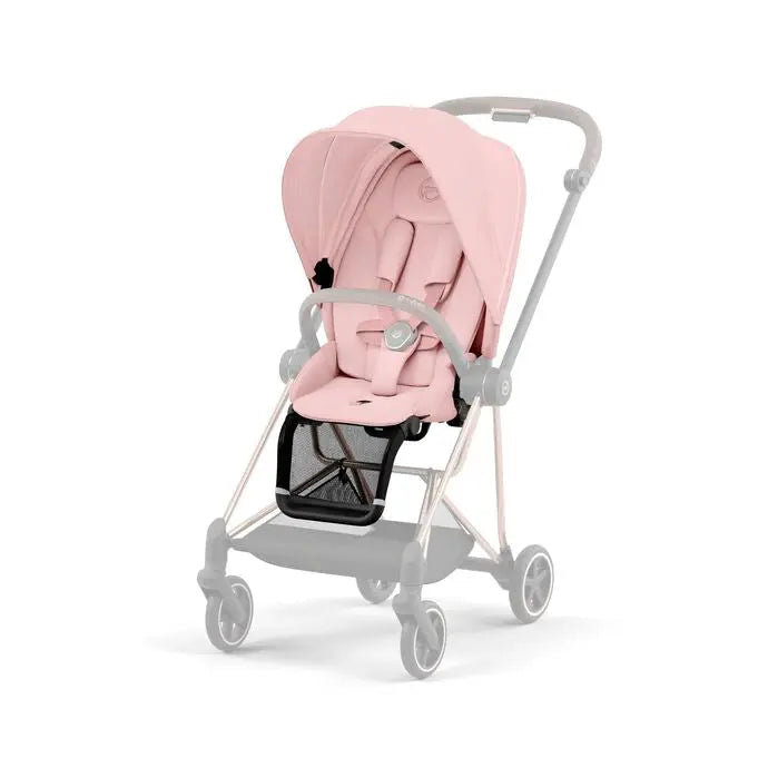 Lifestyle image of the Cybex Mios3 Seat Pack pink stroller with gray frame and canopy, showing padded seat fastened with harness.