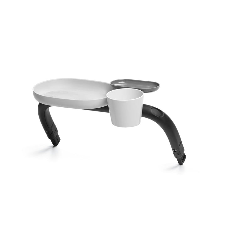 Lifestyle image of the Cybex Platinum Stroller Snack Tray Black with white tray and cup holder, stroller accessory.