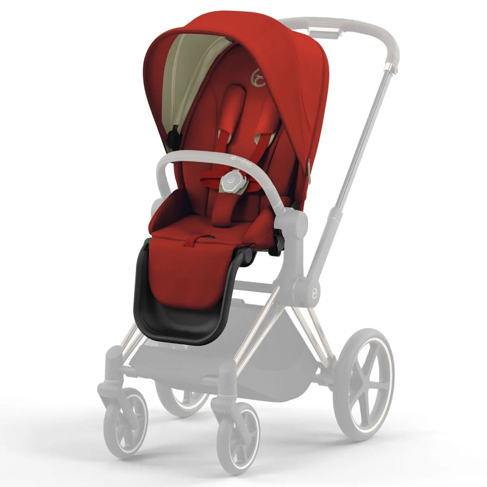 Lifestyle image of the Cybex Priam4/Ep Seat Pack red stroller with canopy, padded seat, and white frame being pushed.