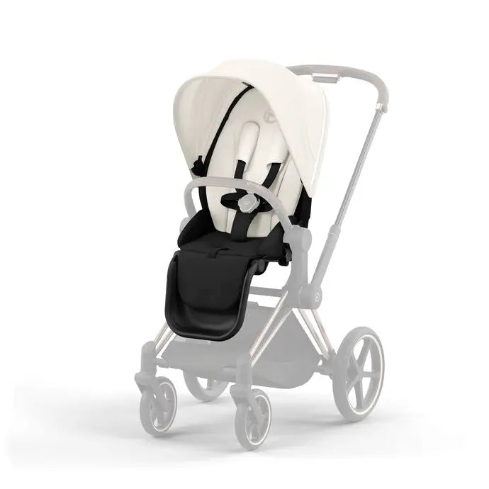 Lifestyle image of the Cybex Priam4/Ep Seat Pack stroller with white canopy and black seat, gray frame, ready for a stroll.