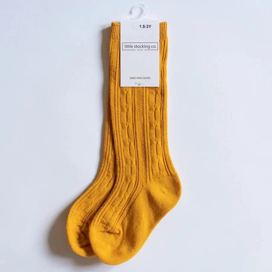 Little Stocking Co. Knee High Socks Marigold on a hanger, showing ribbed knit texture and tag.