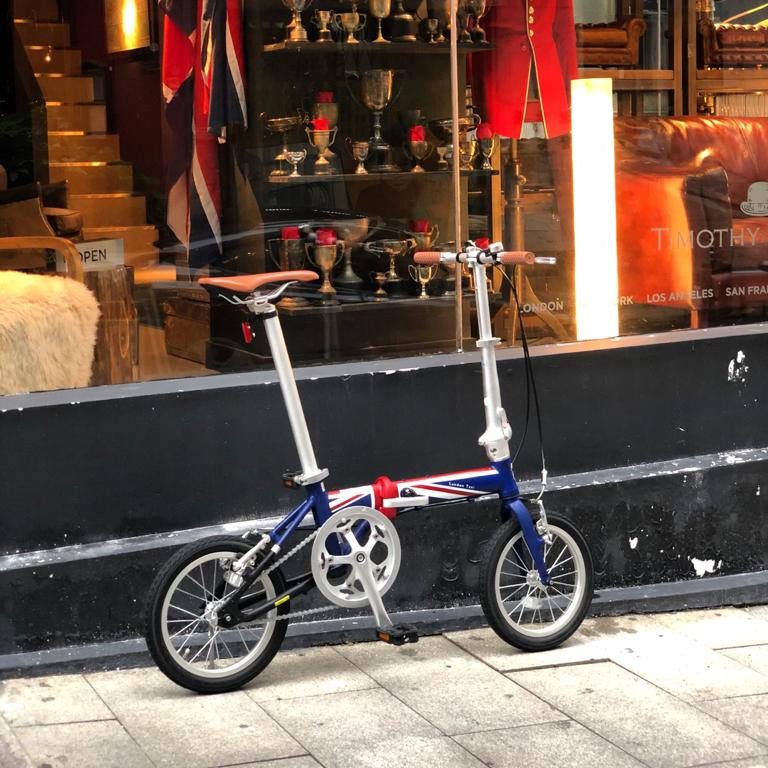 London Taxi folding 14-inch aluminum bicycle in blue, red, and white with Union Jack accents.