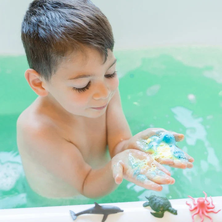 LOOT TOY CO Funky Fish Food Hullabaloo Blue bath foam in a child's hands during bath time