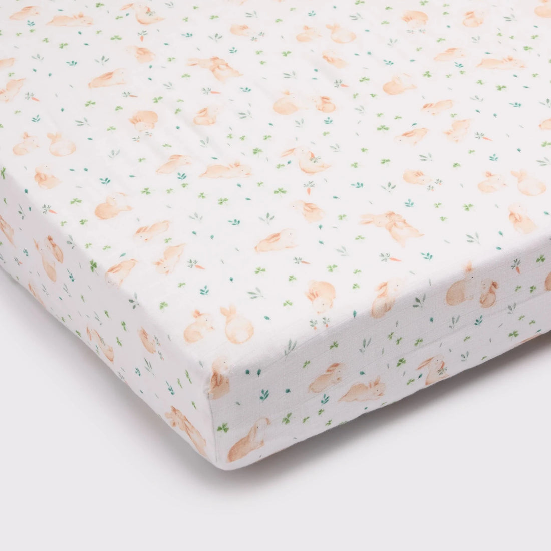 Loulou Lollipop Baby Muslin Fitted Crib Sheet in Tanboocel® Bamboo Viscose - Bunny Meadow — fitted sheet shown over a mattress corner.