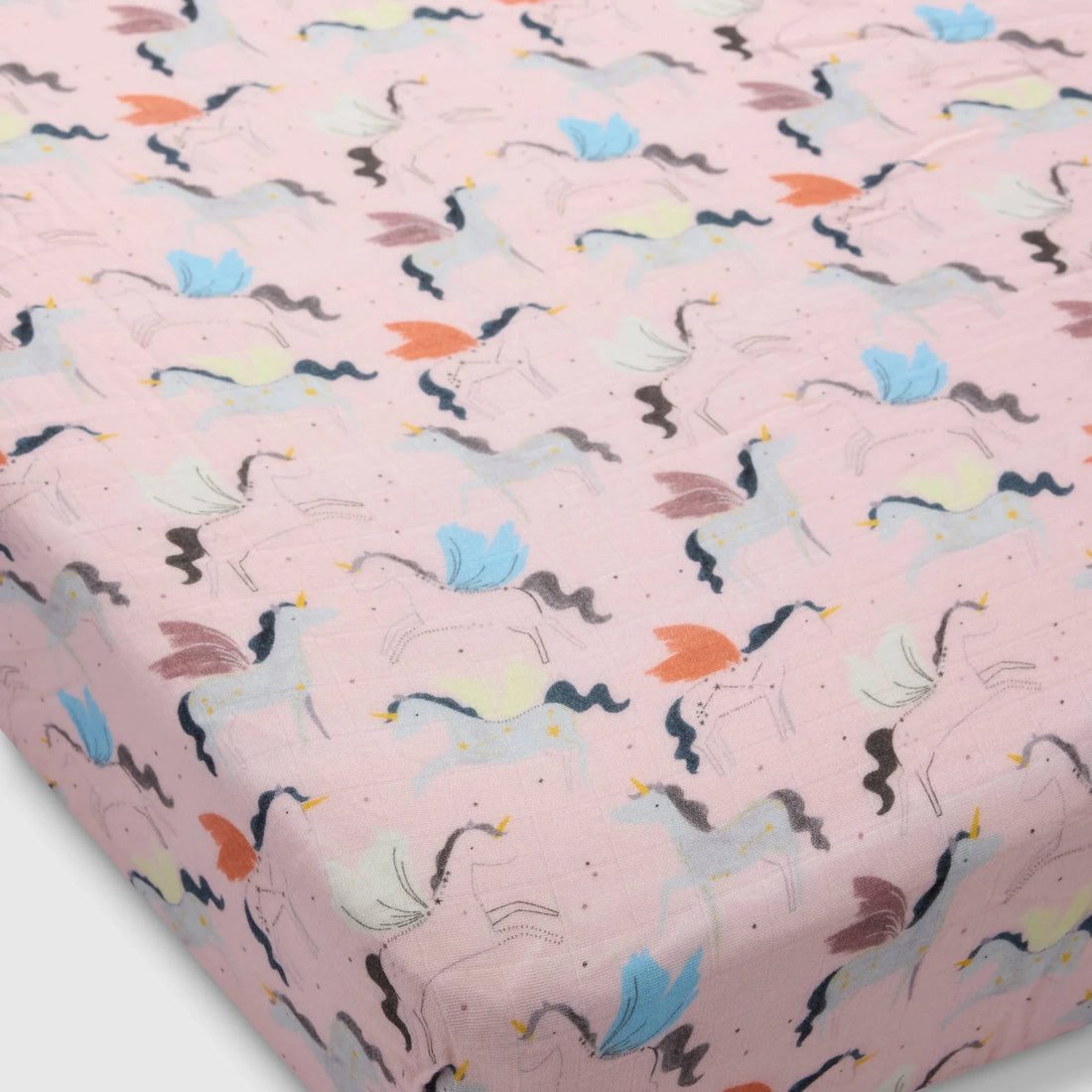 Loulou Lollipop Baby Muslin Fitted Crib Sheet in Tanboocel® Bamboo Viscose - Unicorn Ballet — fitted sheet shown over a mattress corner.