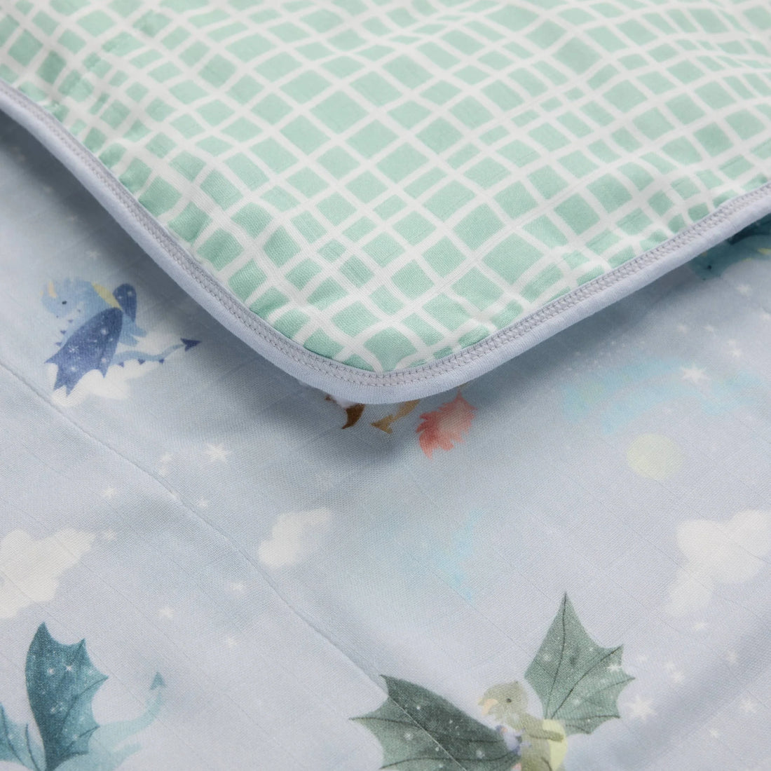 Loulou Lollipop Baby Muslin Quilt in Tanboocel® Bamboo Viscose - Magical Dragons — close-up of fabric, print and construction.