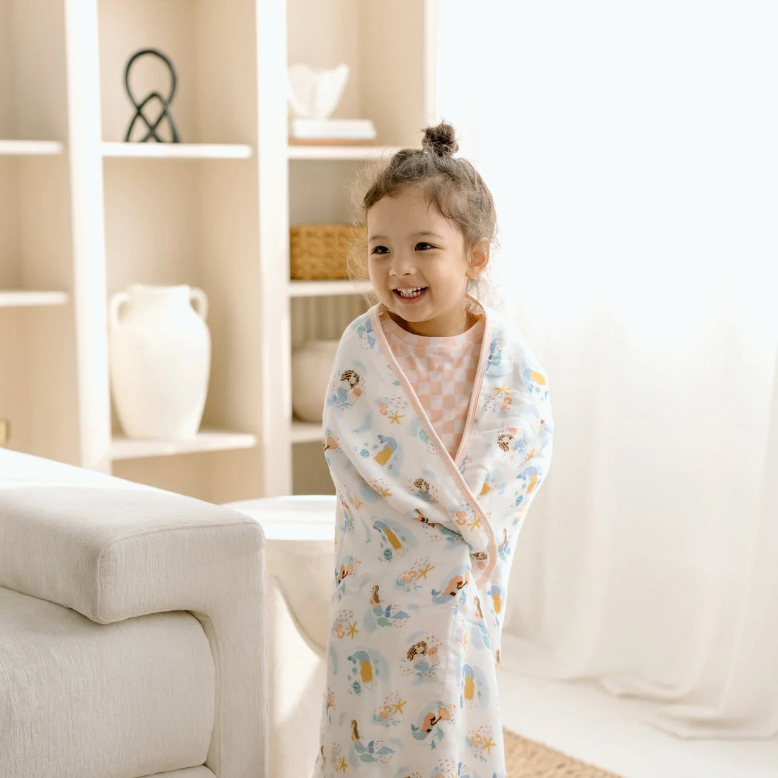 Loulou Lollipop Baby Muslin Quilt in Tanboocel® Bamboo Viscose - Mermaids — quilt blanket shown in a nursery setting.