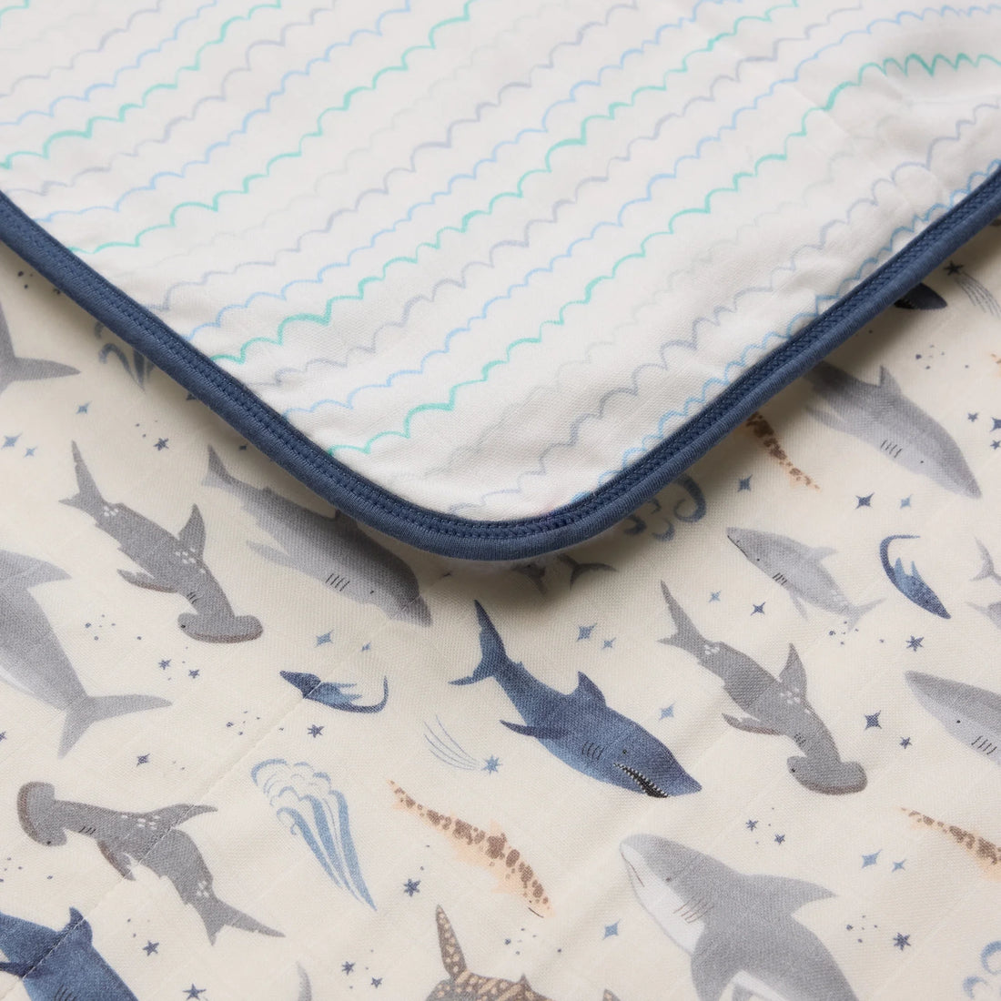 Loulou Lollipop Baby Muslin Quilt in Tanboocel® Bamboo Viscose - Smiley Sharks — close-up of fabric, print and construction.
