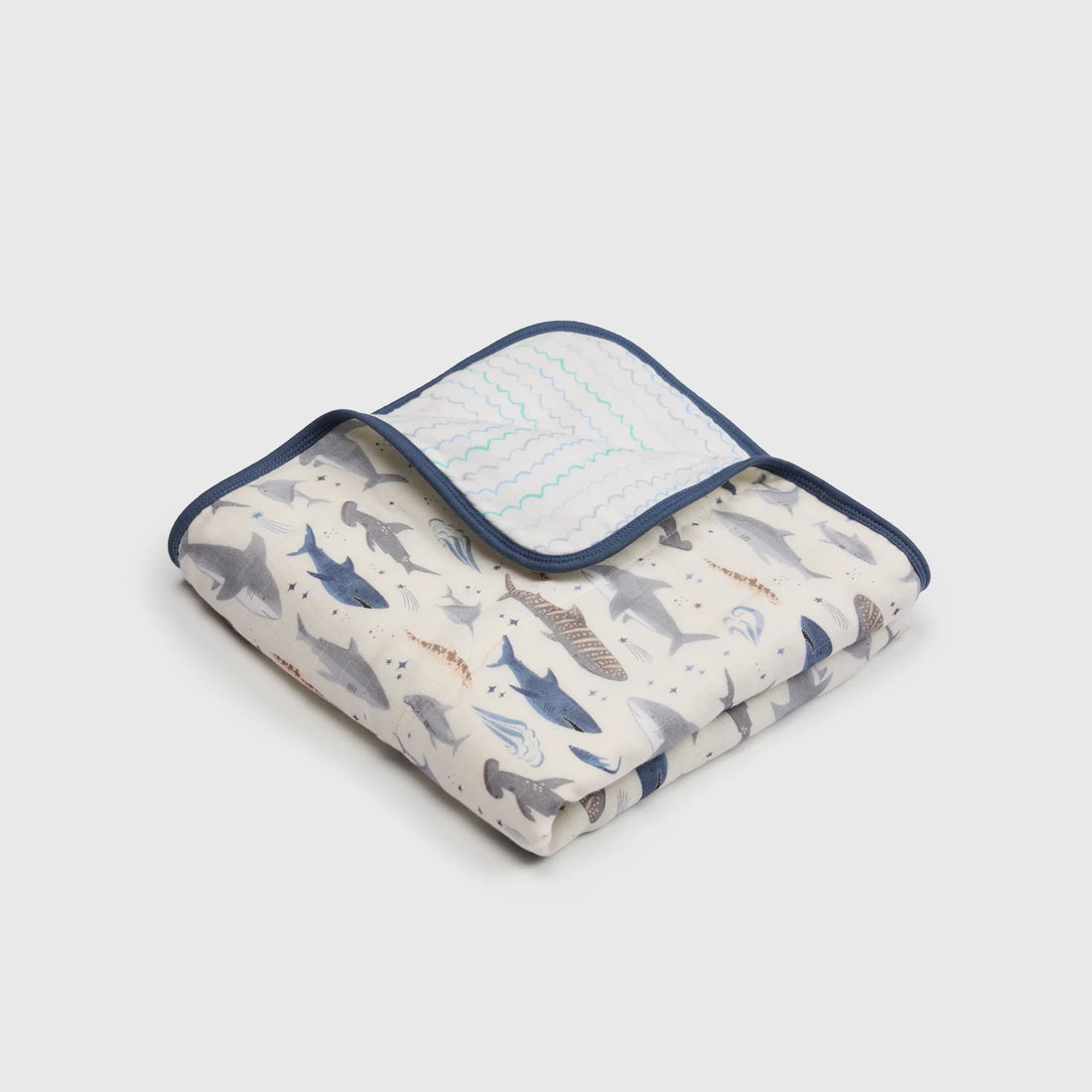 Loulou Lollipop Baby Muslin Quilt in Tanboocel® Bamboo Viscose - Smiley Sharks — folded quilt showing the printed front and reverse.