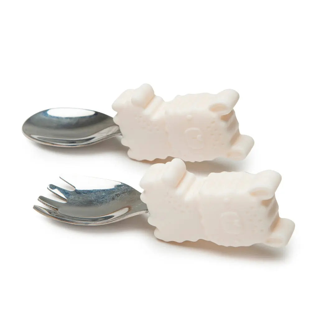 Loulou Lollipop Born To Be Wild Learning Spoon/Fork Set, white animal-handle utensils with stainless heads.