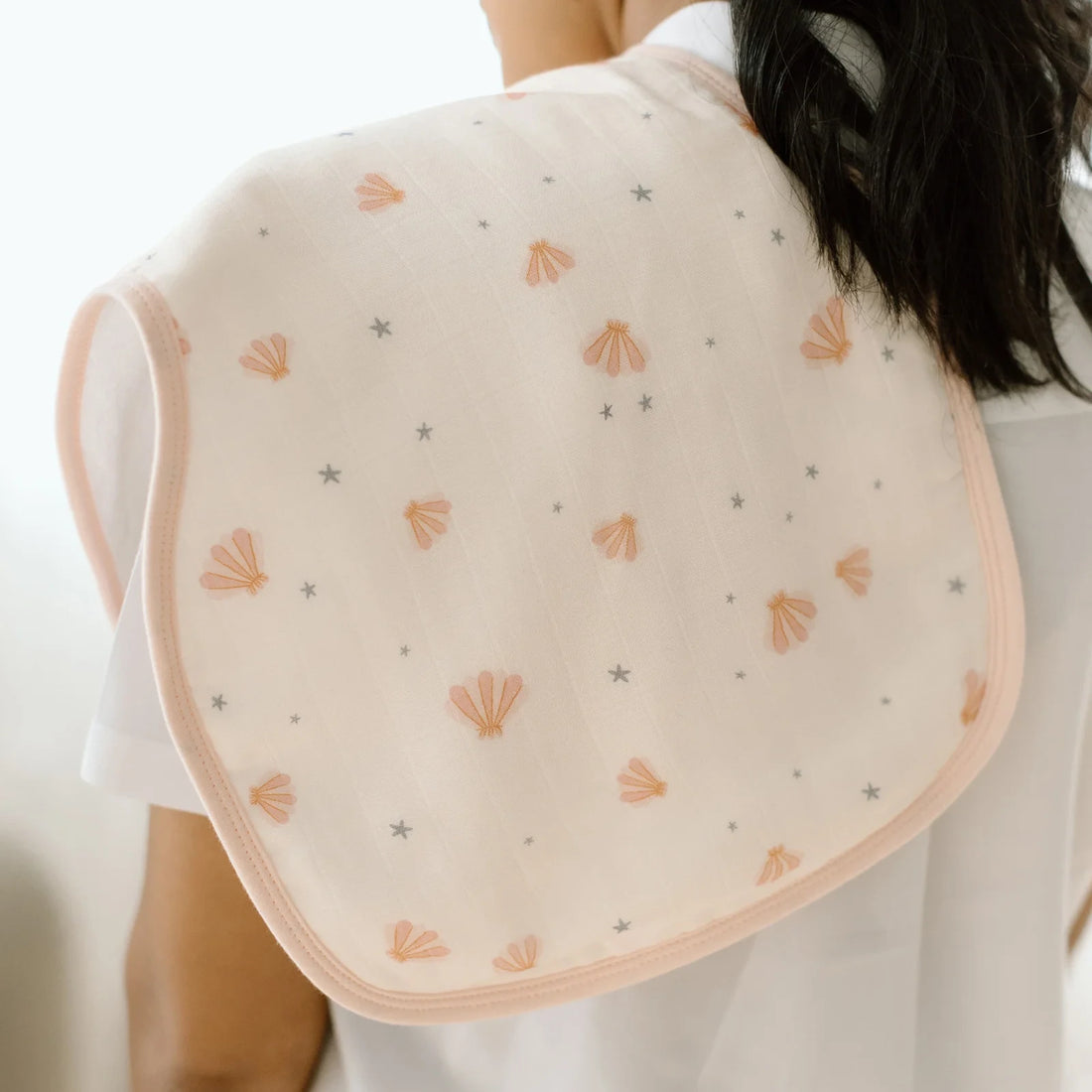Loulou Lollipop Burp Cloth Set - 2 Pack - Mermaids — burp cloth draped over a caregiver shoulder.