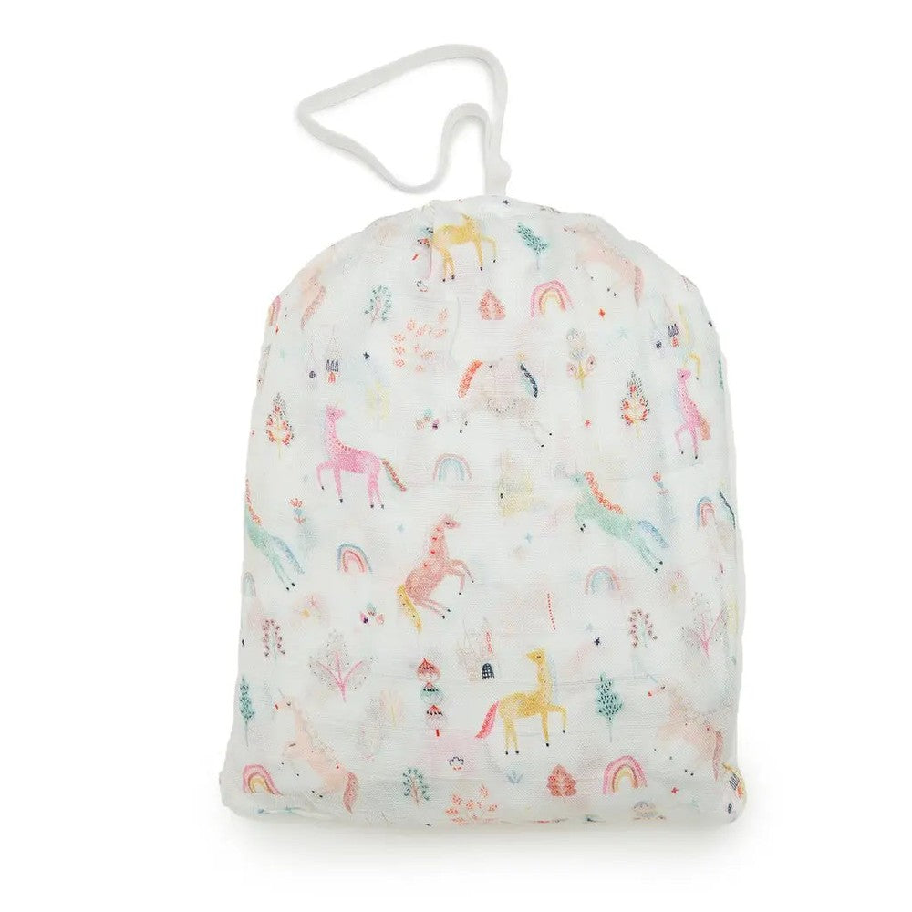 LOULOU LOLLIPOP fitted crib sheet in pastel unicorn print, shown folded in a soft white bag with drawstring.