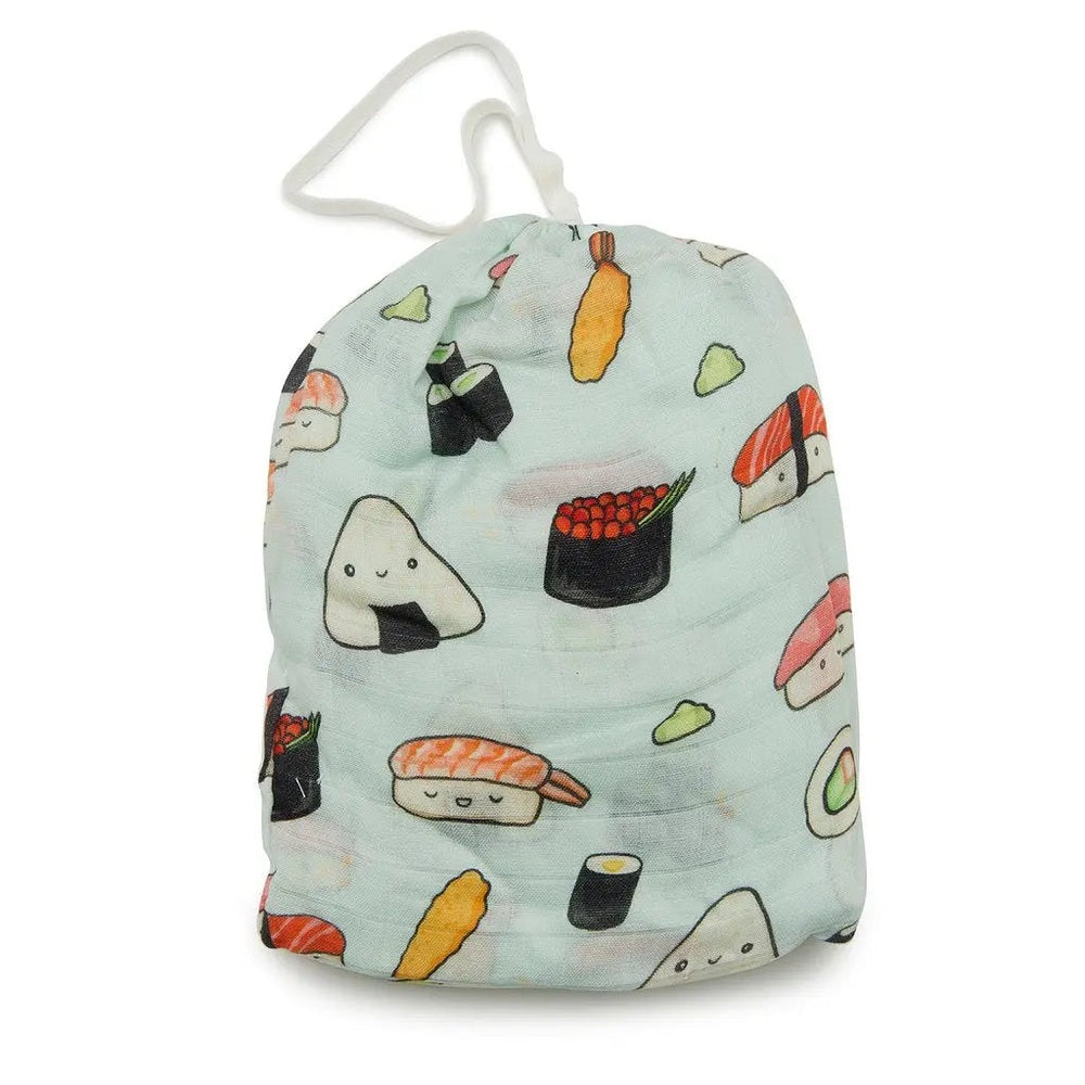 LOULOU LOLLIPOP fitted crib sheet snugly covers a crib mattress, featuring a pastel sushi print.
