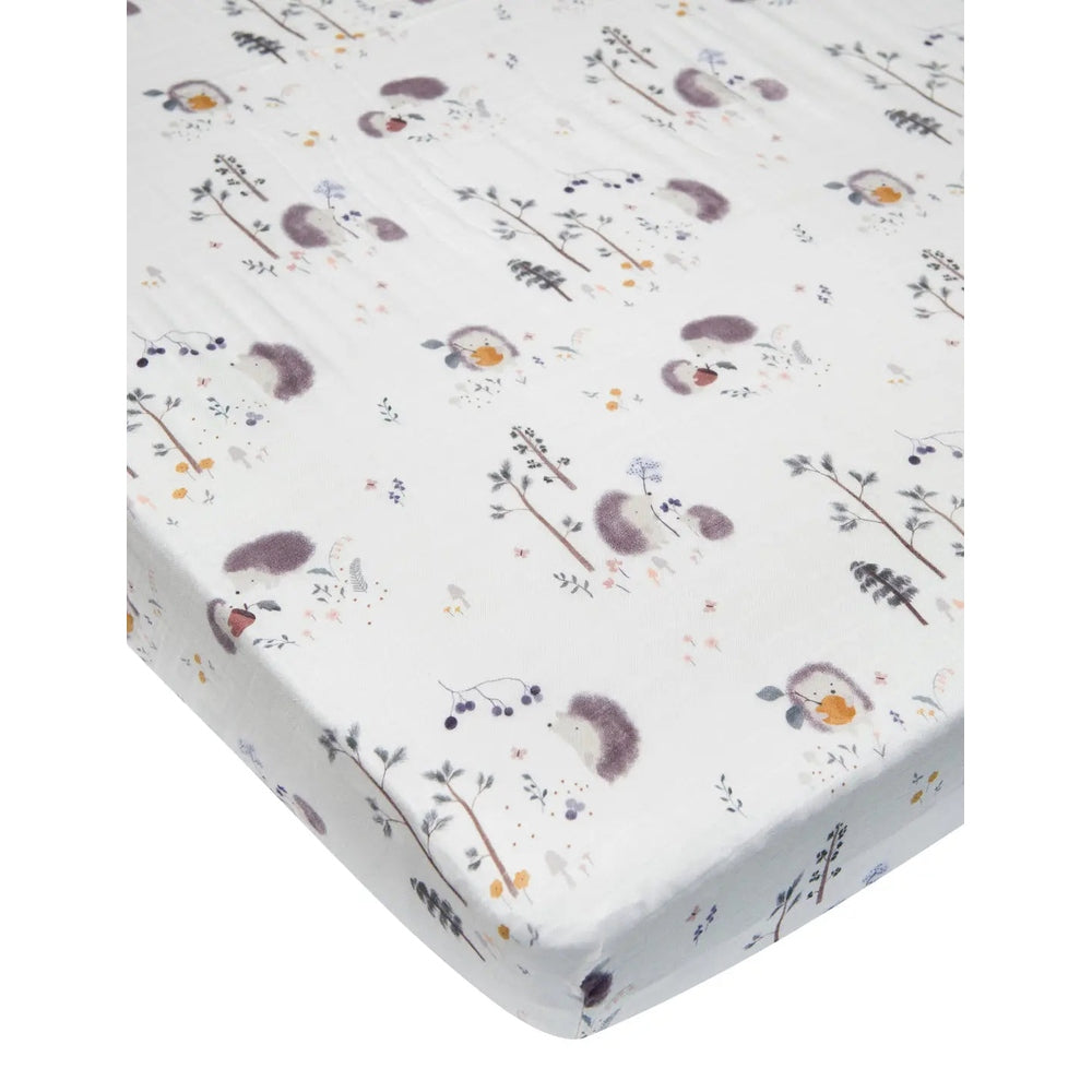 Loulou Lollipop Fitted Crib Sheet in white with whimsical woodland print; elastic corner-fit around mattress.