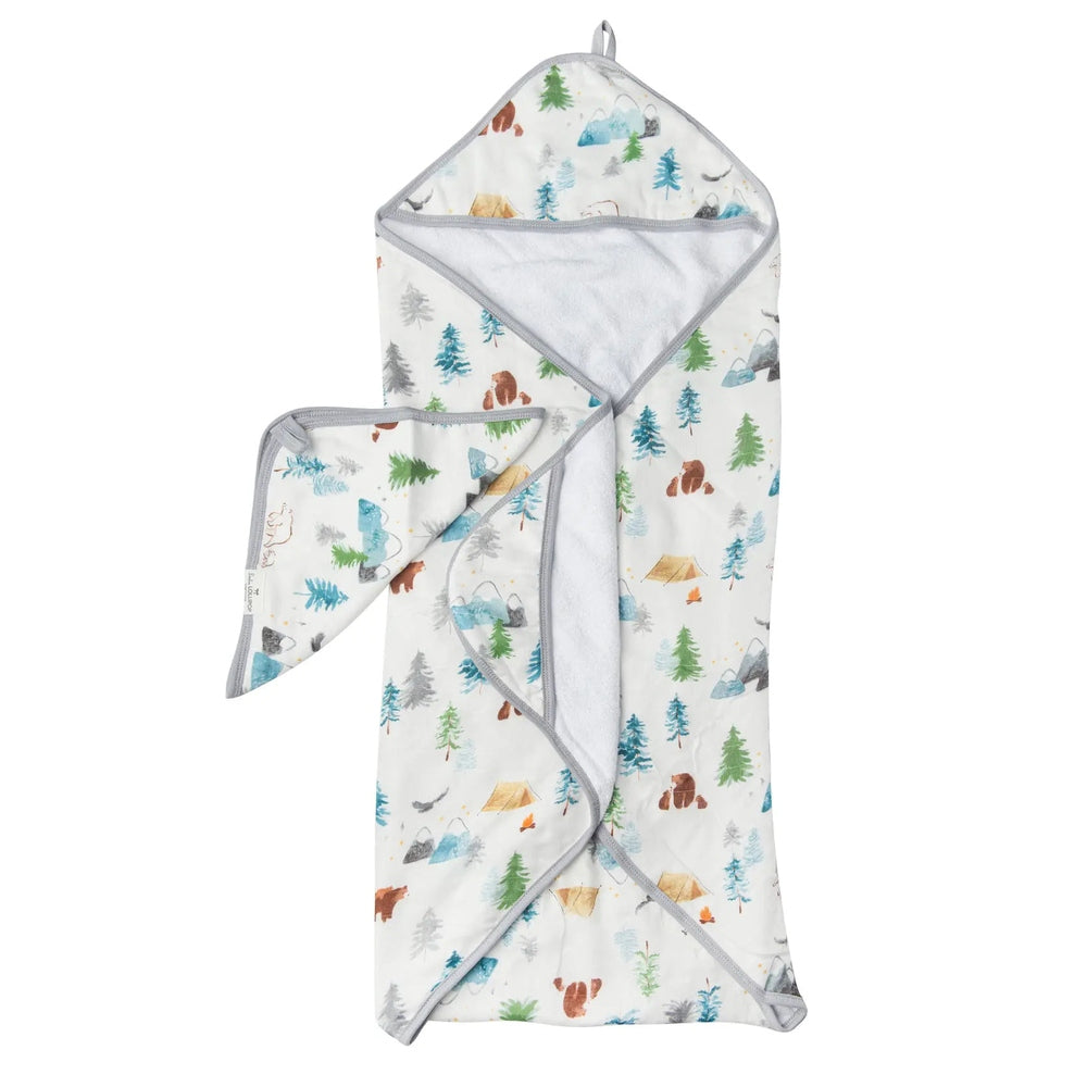Loulou Lollipop Hooded Towel Set with woodland print, white fabric and gray trim; hooded towel and washcloth laid out.