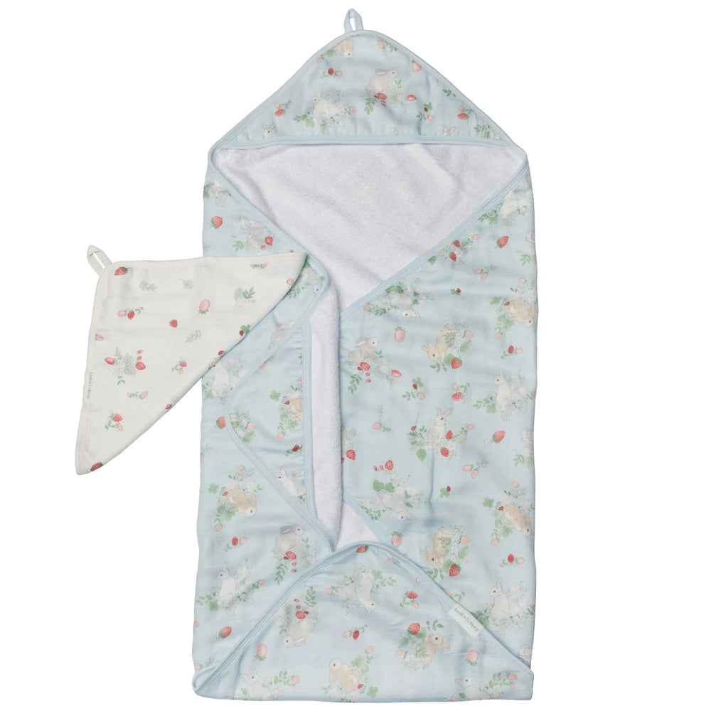 Loulou Lollipop hooded towel set in pale blue bunny and strawberry print; baby wraps in the hooded towel.