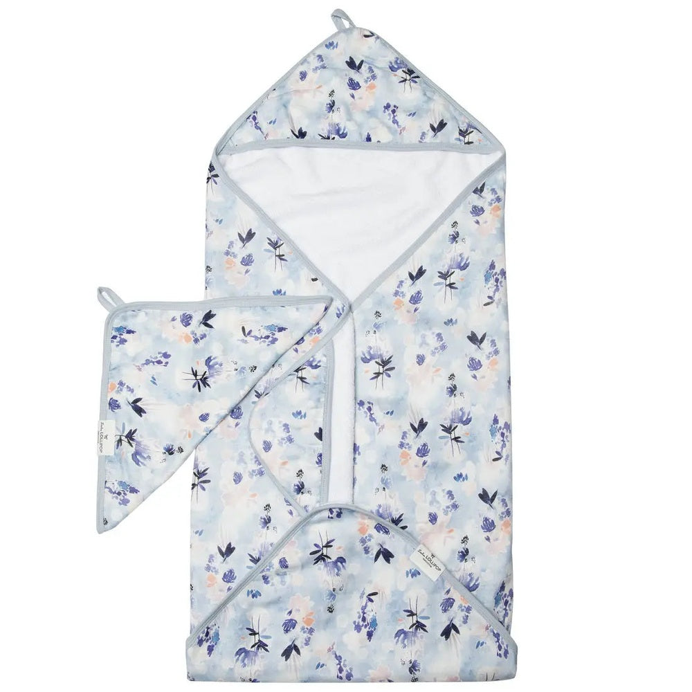 Loulou Lollipop Hooded Towel Set in pale blue floral print, hooded towel with matching washcloth laid beside.