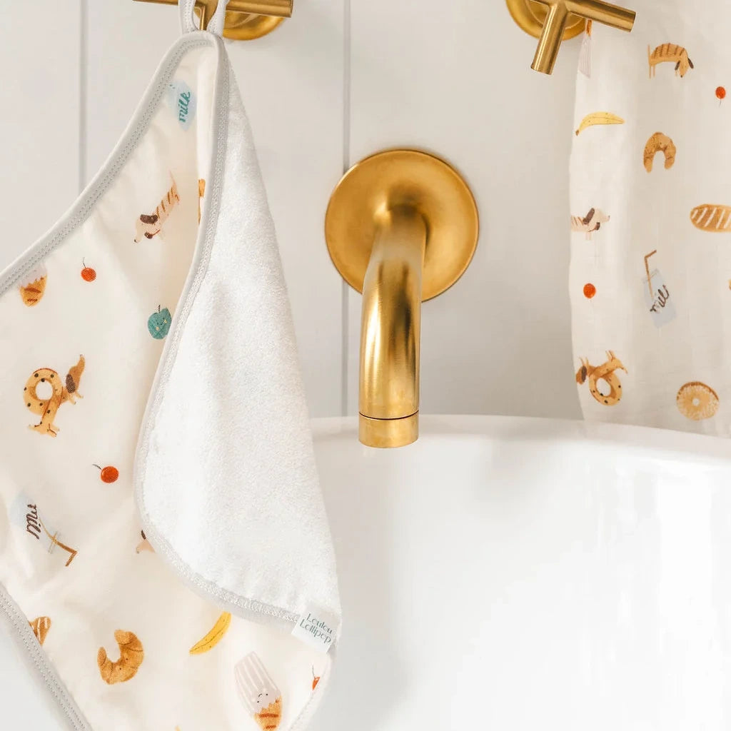 Loulou Lollipop Hooded Towel Set - French Breakfast — hooded towel shown during baby bath time.