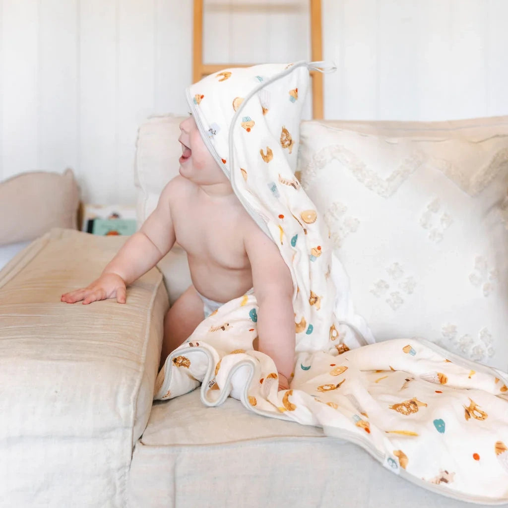 Loulou Lollipop Hooded Towel Set - French Breakfast — hooded towel shown during baby bath time.