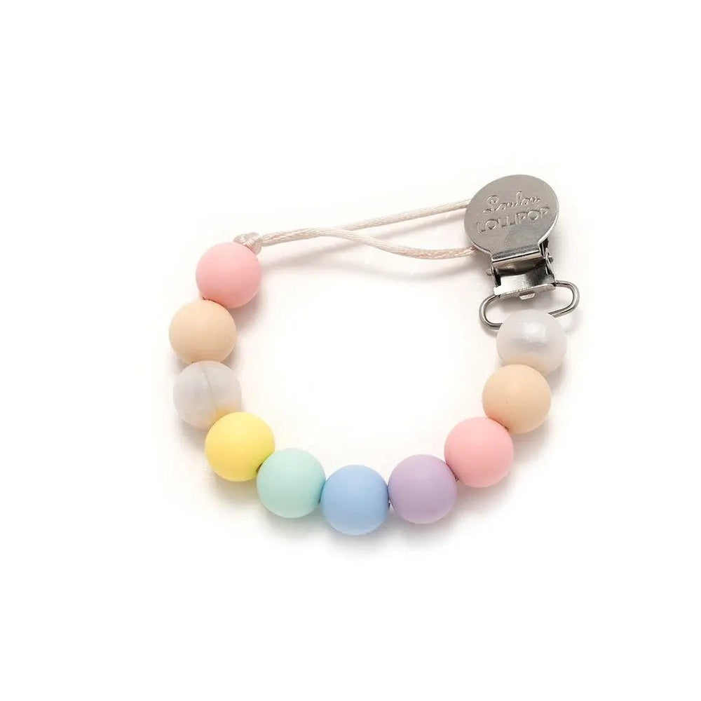Loulou Lollipop Lolli Silicone Pacifier Clip with pastel beads, metal clip fastens to a baby outfit.