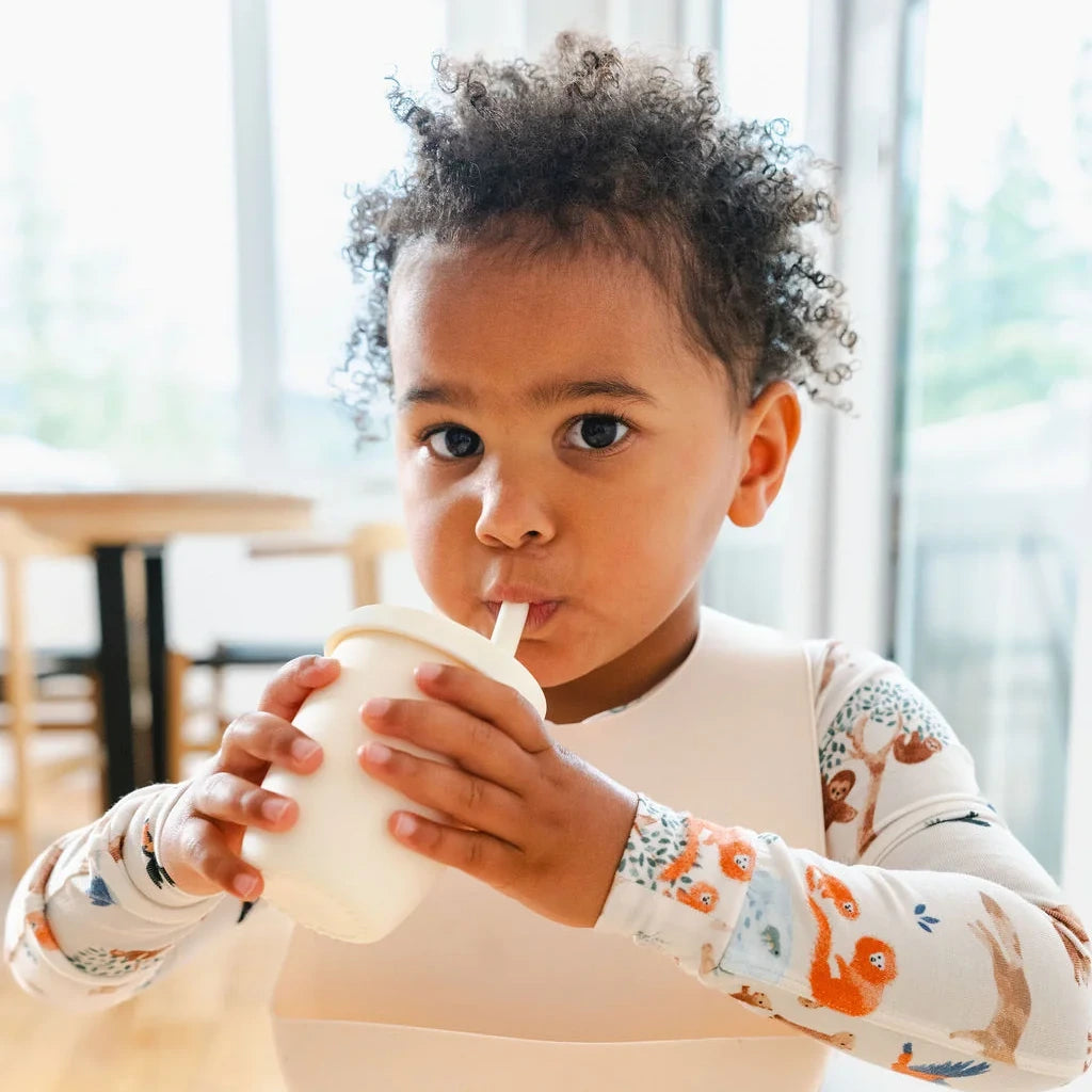 Loulou Lollipop Long Sleeve Pajama Set - Llama Adventures — child drinking from a cup while wearing the pajamas.