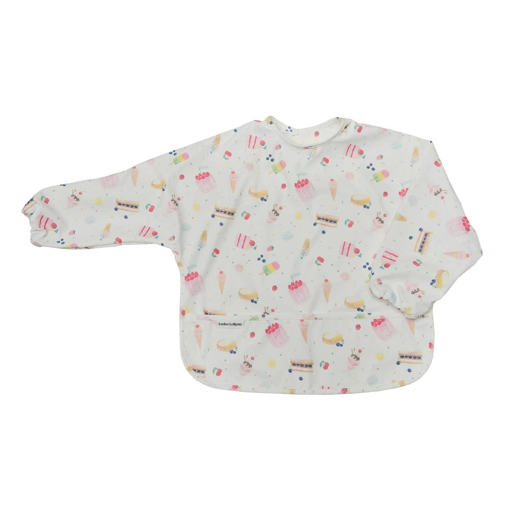Loulou Lollipop Long Sleeve Waterproof Bib in pastel dessert print, laid flat to show waterproof sleeves and front pocket.