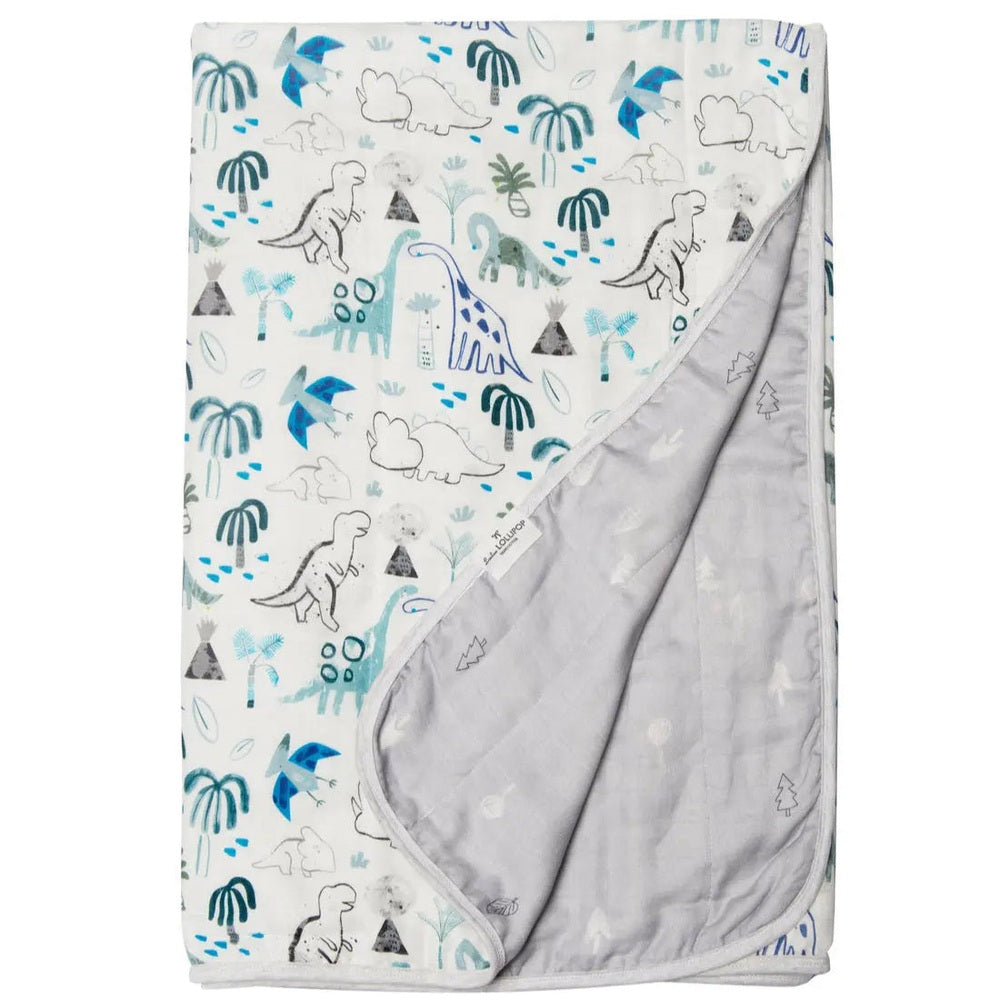 Loulou Lollipop Muslin Quilt Blanket with blue dinosaur jungle print; soft muslin fabric shown folded to reveal the gray reverse.