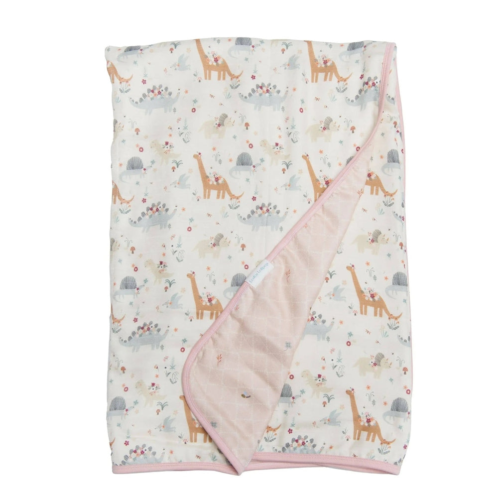 LOULOU LOLLIPOP Muslin Quilt Blanket in pastel dinosaur print with pink trim, folded to reveal soft pink reverse.
