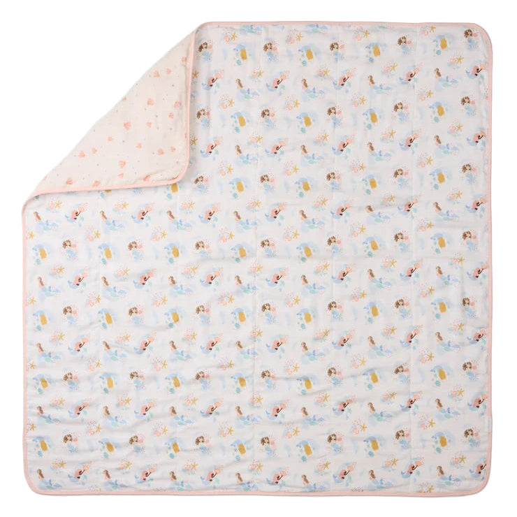 Loulou Lollipop Muslin Quilt Blanket in pastel print with pink edging, folded corner reveals reverse fabric.