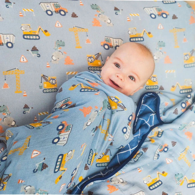 Loulou Lollipop Muslin Quilt - Tiny Engineers — quilt blanket shown in a nursery setting.