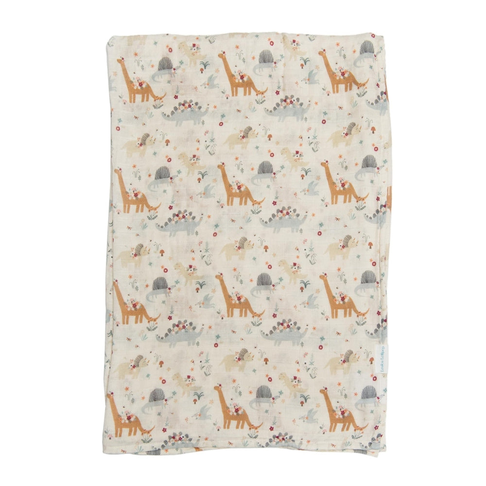 Loulou Lollipop Muslin Swaddle spread flat, showing soft breathable fabric and pastel dinosaur/giraffe print.