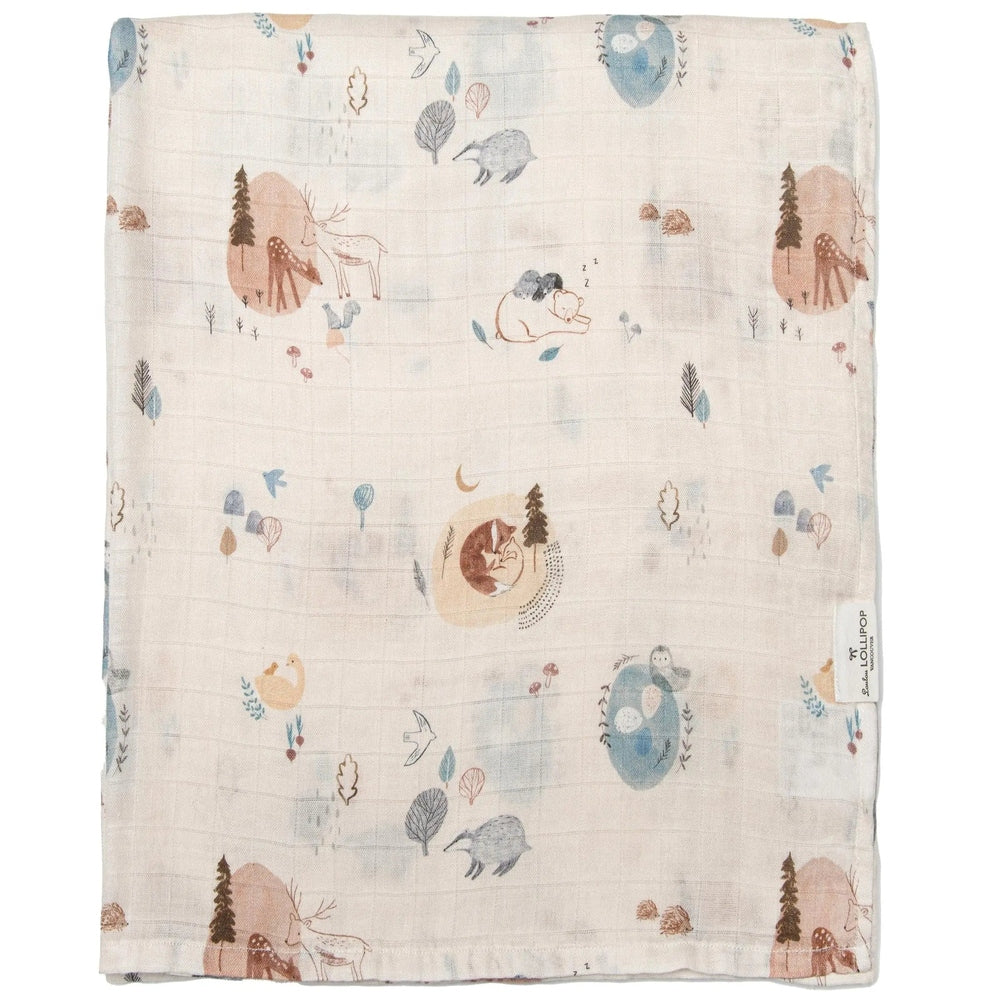 Loulou Lollipop Muslin Swaddle blanket in cream with pastel woodland animals, folded flat to show soft breathable fabric.