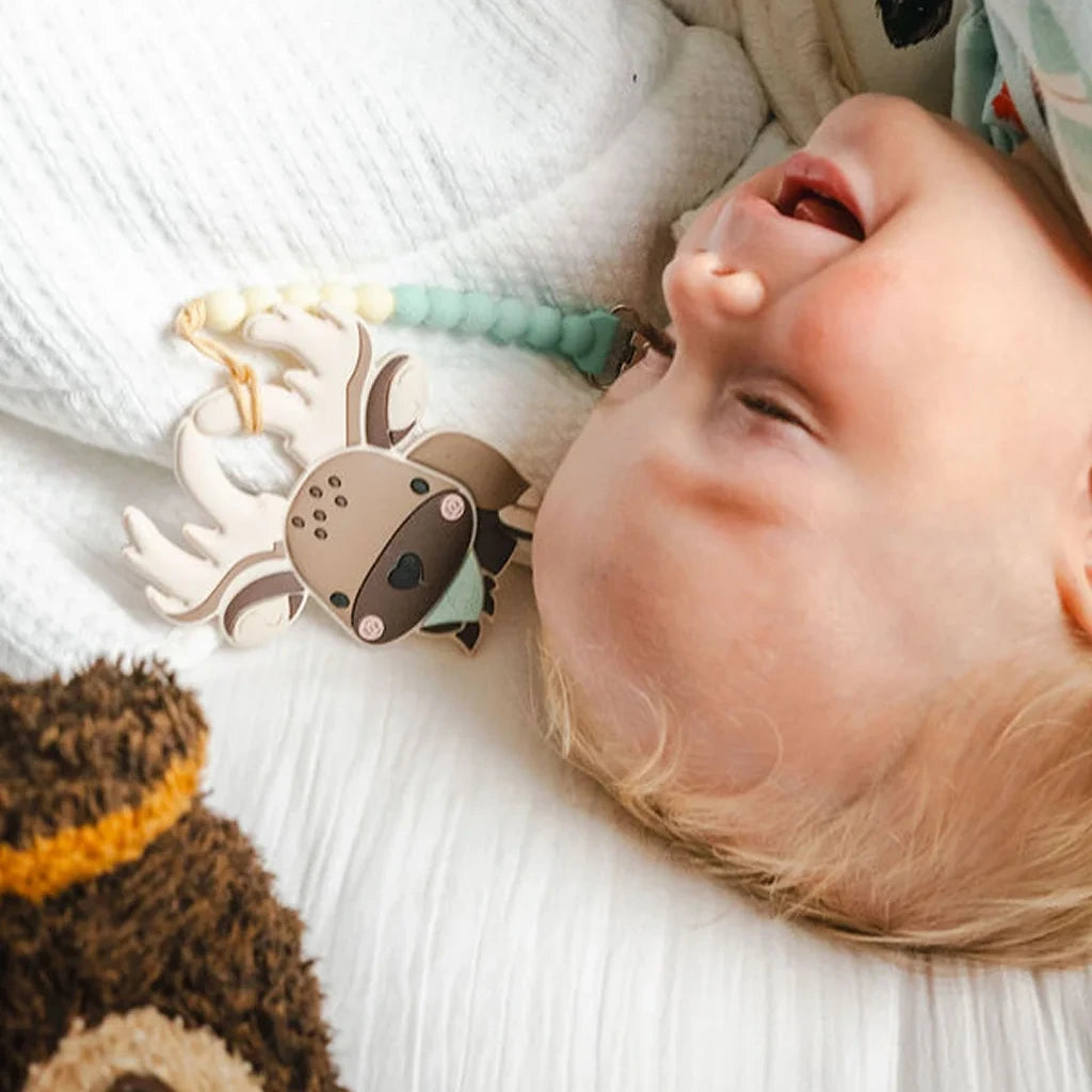 Loulou Lollipop OneC™ Silicone Clip Teether Set - Moose — baby holding or using the silicone teether.