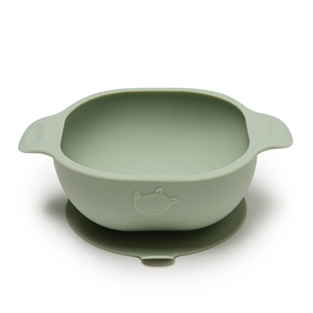Loulou Lollipop Silicone Snack Bowl in pale green with bear imprint, sitting on a matching plate for stable feeding.