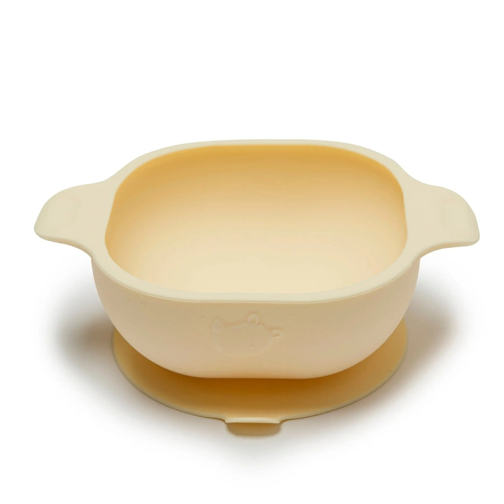 Loulou Lollipop Silicone Snack Bowl in cream with dual side handles, shown ready for baby mealtime.