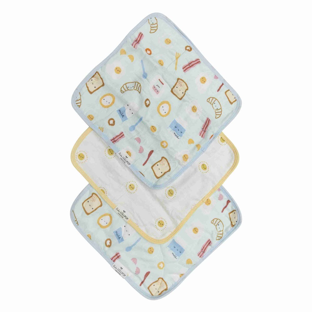 Loulou Lollipop Washcloth 3-Piece Set, pale blue with breakfast print, shown stacked to reveal soft fabric and yellow trim