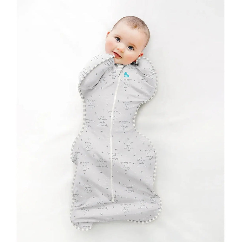 Love To Dream Swaddle Up Cotton 0.2 Tog You Are My Grey swaddled baby resting with arms up in grey fabric with white piping