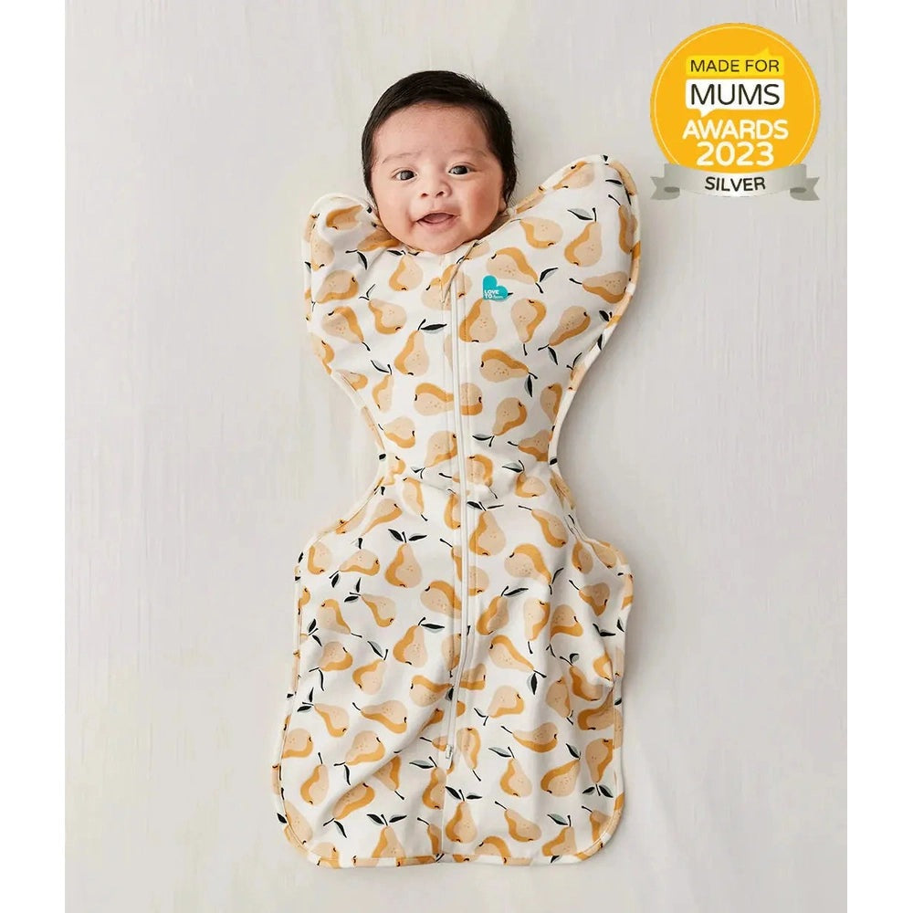 LOVE TO DREAM Swaddle Up Original Cotton 1.0 Tog Pear Print Ochre swaddle on a smiling baby, showing the front zipper for snug fit.