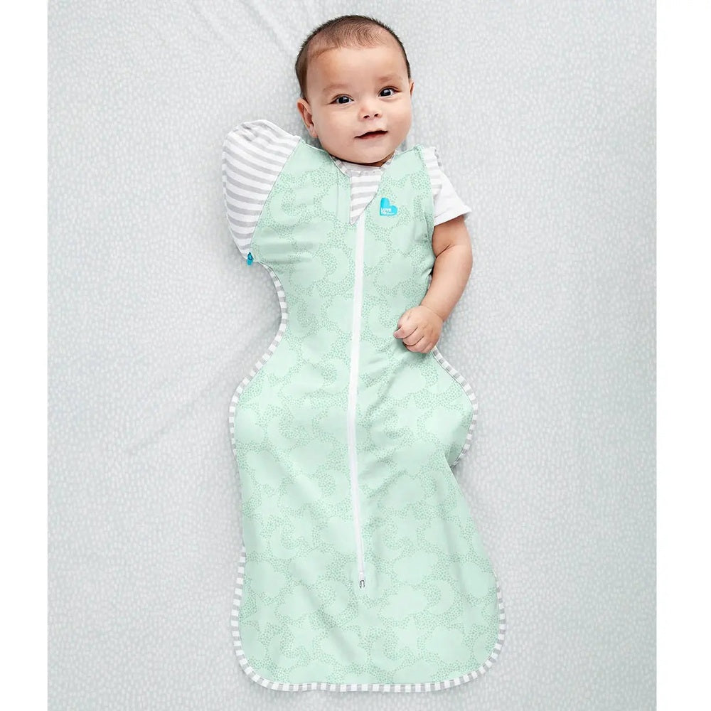 Love To Dream Swaddle Up Transition Bag 1.0 Tog mint Celestial Dot, baby lying on back with zipper closed.