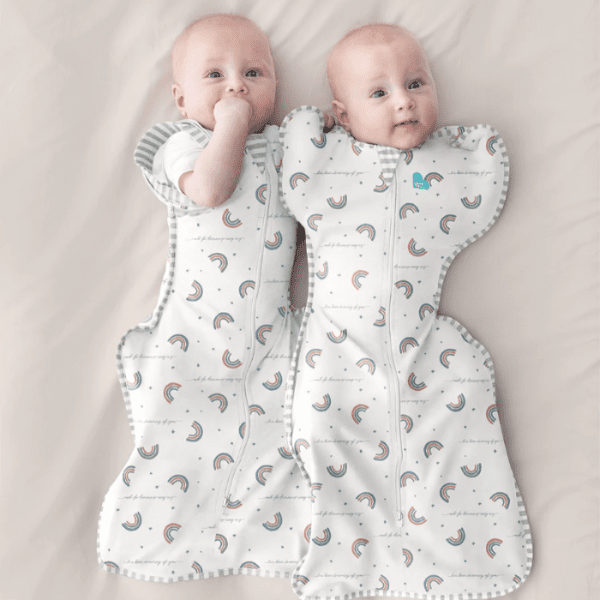 Love To Dream Swaddle Up Transition Bag Original Cotton 1.0 in white rainbow print worn by two babies