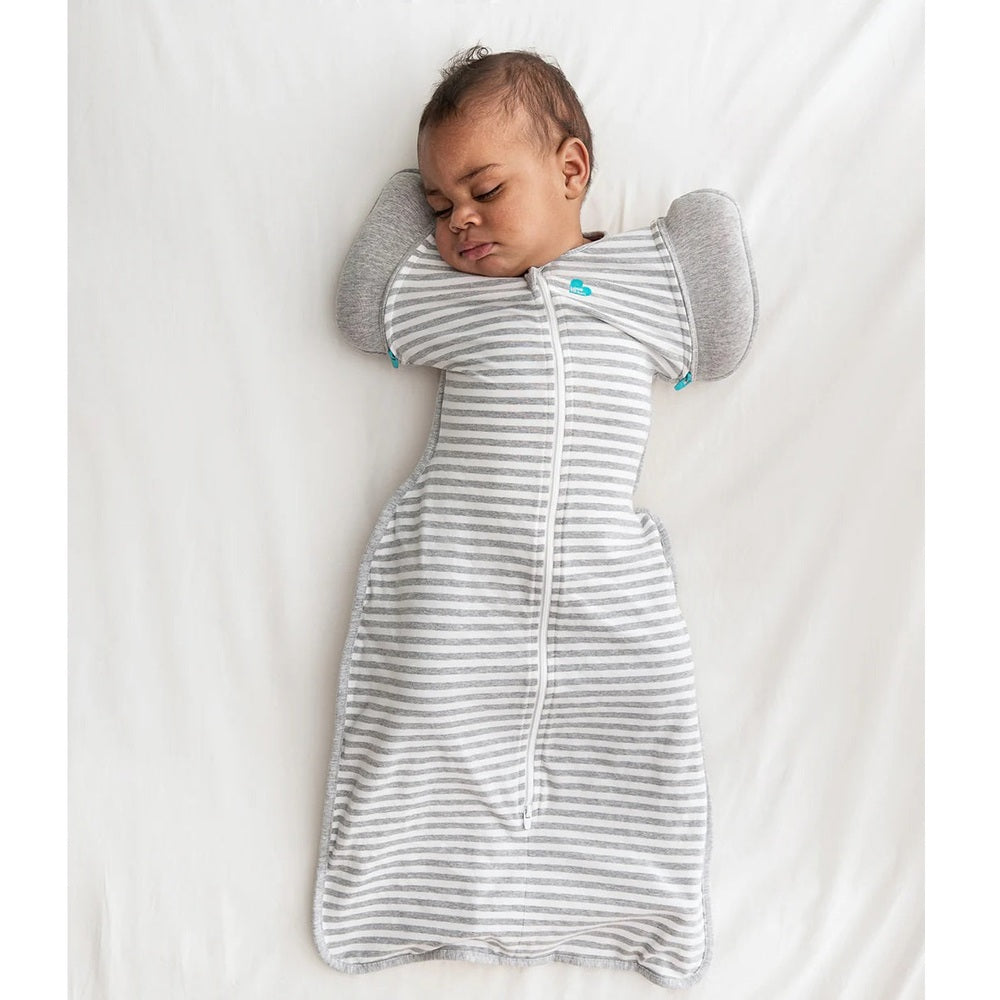 Love To Dream Swaddle Up Transition Bag Original Cotton 1.0 Tog Grey; sleeping baby in grey-striped swaddle.