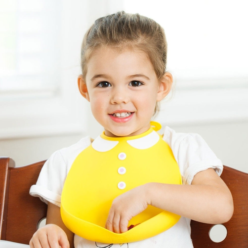 Make My Day baby bib with yellow Peter Pan collar, worn by a smiling toddler during mealtime