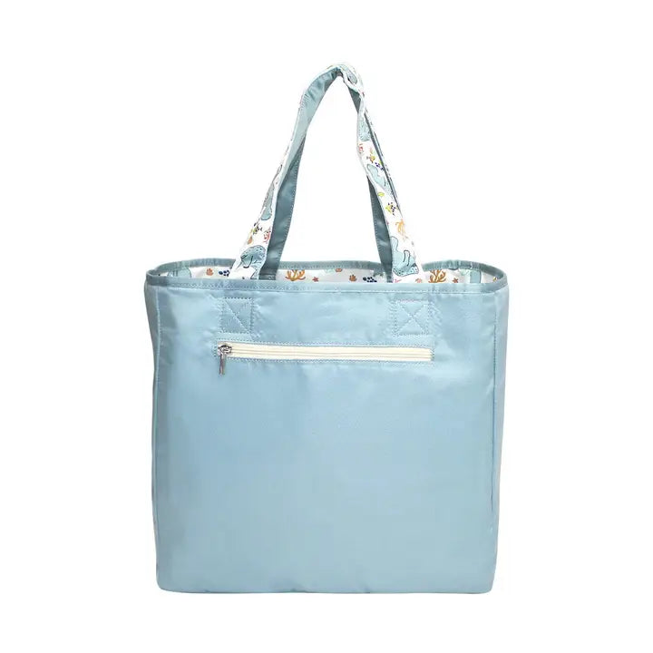 Light blue tote bag with floral handle on a white background