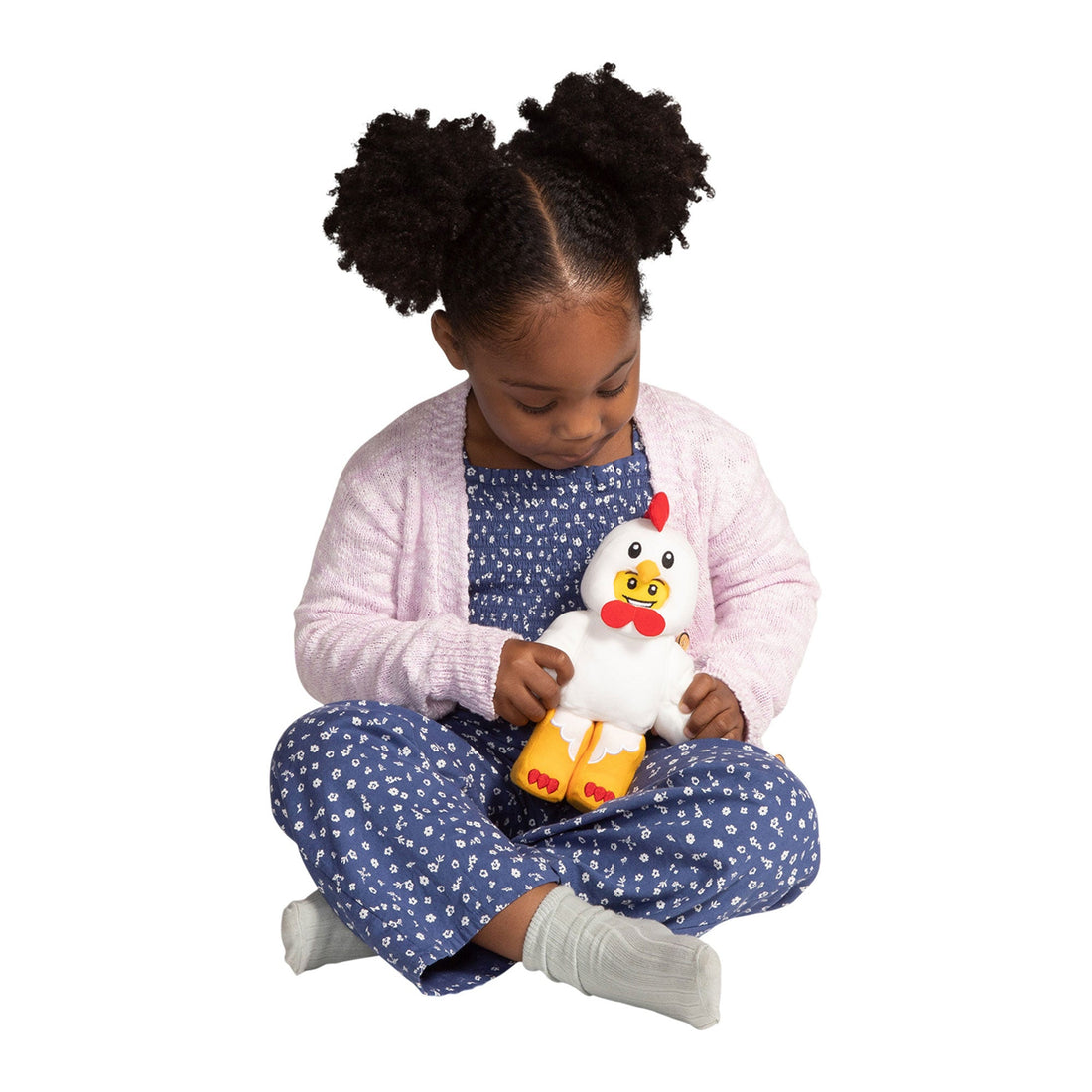 Manhattan Toy LEGO Minifigure Chicken Suit Guy 9" Plush - child holding the plush while seated